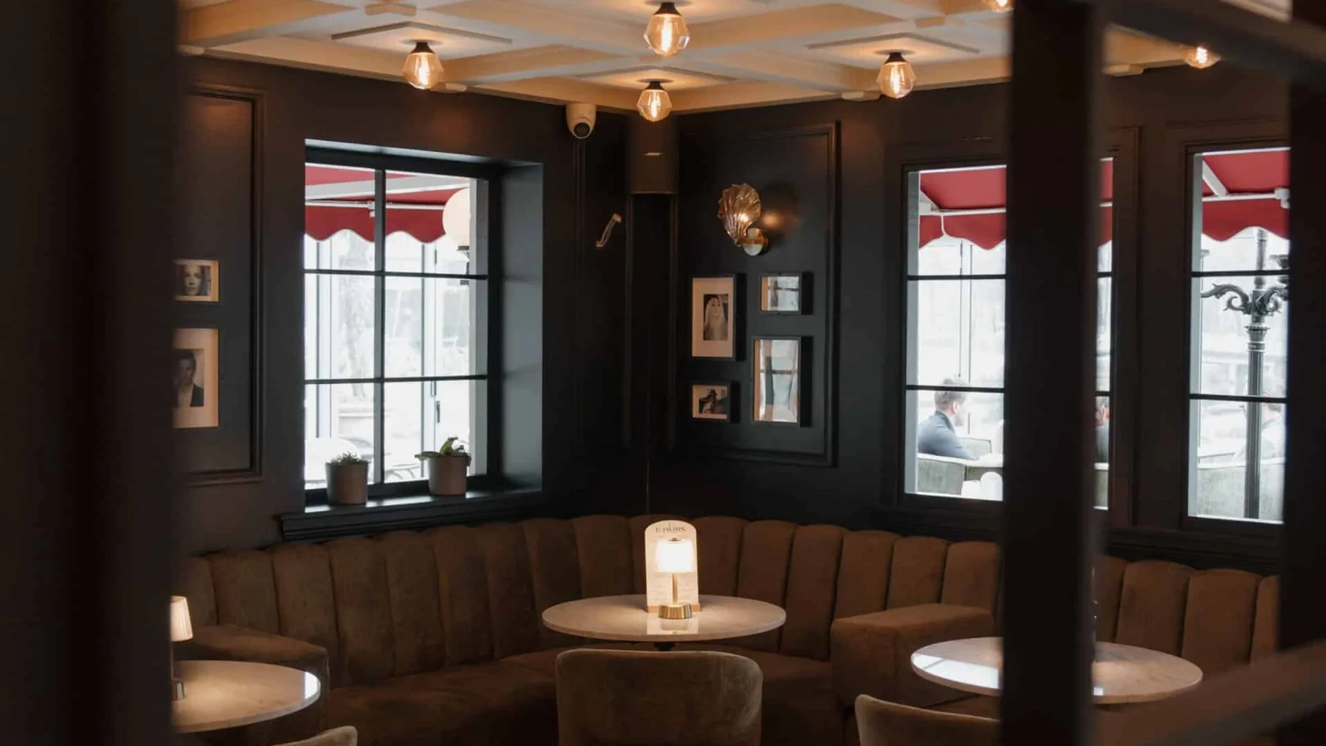 The interior of Le Paris in Leidschendam, with velvet seating, round tables and soft lighting