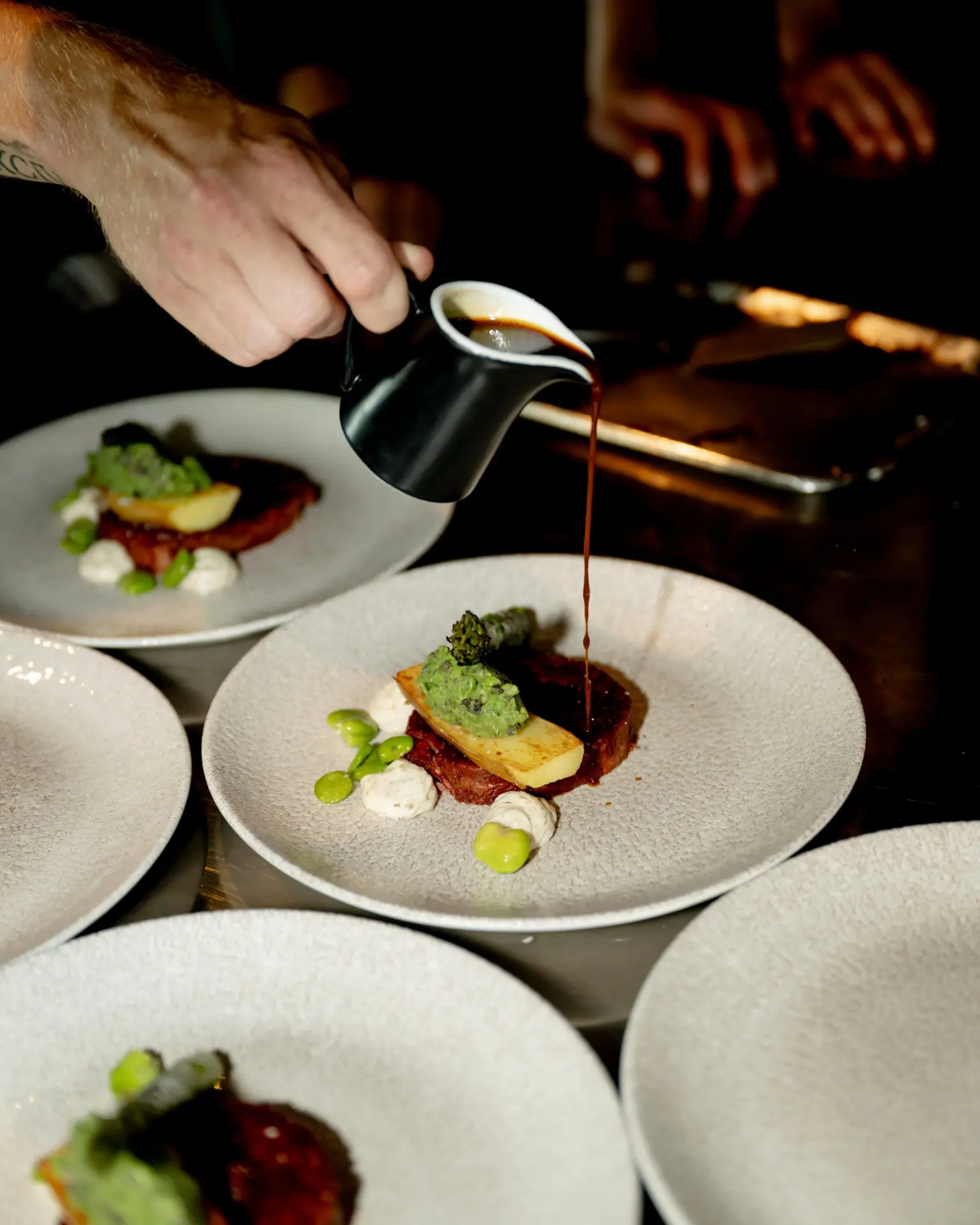A dish being finished at MOON Amsterdam